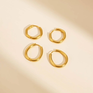 Detailed set of gold U-shaped hexagonal and oval earrings with polished finish