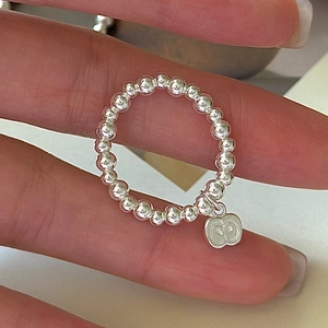 Minimalist S925 sterling silver beaded ring with a small metal apple-shaped pendant charm