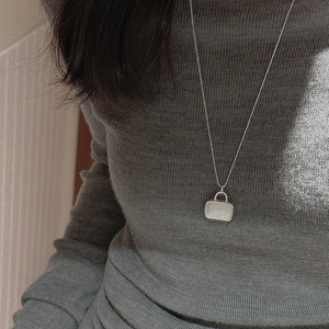 Minimalist S925 sterling silver handbag pendant necklace on grey knit sweater