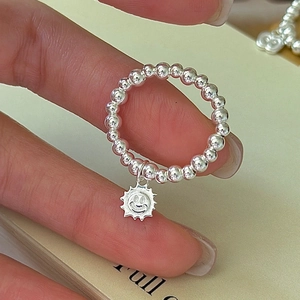 S925 sterling silver beaded ring with a smiling sun pendant on a hand model