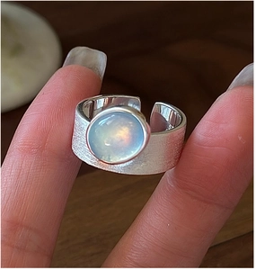 Close-up of S925 sterling silver ring with brushed texture and blue moonstone