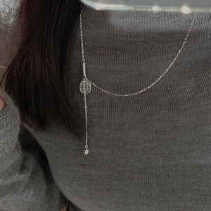S925 sterling silver tennis racket necklace with bead pendant on grey sweater