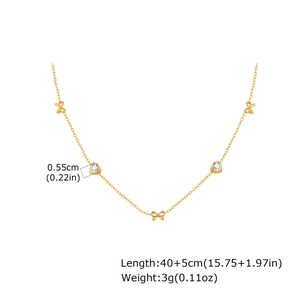 Golden stainless steel necklace featuring bow accents and clear heart-shaped crystals