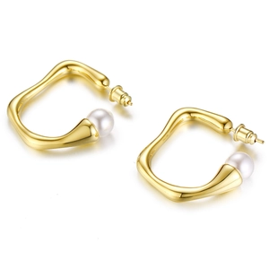 Close-up of irregular gold earrings with high-polish finish and white pearls