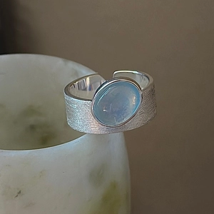 S925 sterling silver ring with aquamarine stone and brushed metal texture on ceramic