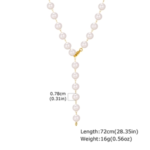 Detail of gold Y-shaped necklace with 0.78cm white pearls and lobster clasp closure