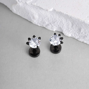 Detail of gothic dragon claw stud earrings with white zircon in a black finish