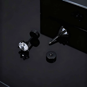 Macro view of black stainless steel stud earrings with white zircon in six-prong setting