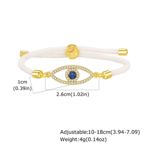 Detailed view of evil eye bracelet with white braided cord and gold-plated pendant