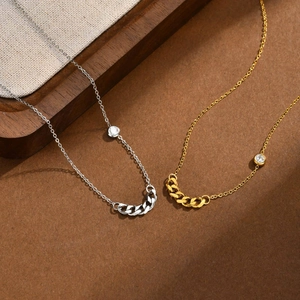 Detail of gold and silver cuban chain necklaces with round zircon on leather