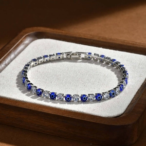 Detailed close-up of hip-hop tennis bracelet with zircon stones and blue evil eye charms