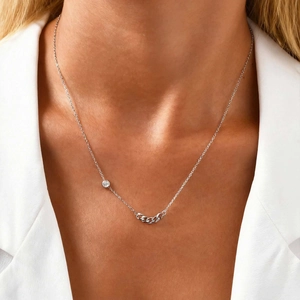 Close-up of minimalist silver necklace with zircon stone and flat chain link on model
