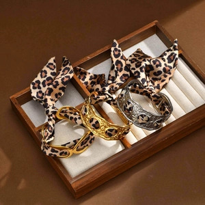 Gold and silver metal bangles set wrapped in leopard print silk ribbons for women
