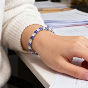 Detailed close-up of evil eye bracelet with blue stones and clear cubic zirconia on wrist