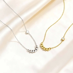 Minimalist stainless steel zircon necklaces in silver and gold on beige silk fabric