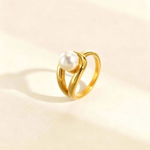 Detail of 18K gold stainless steel ring with white pearl and twisted band design