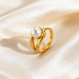 Detailed macro view of an 18K gold stainless steel ring with a water drop pearl on silk