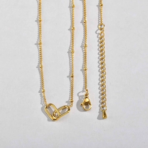 Minimalist gold stainless steel beaded necklace with interlocked oval heart pendant detail
