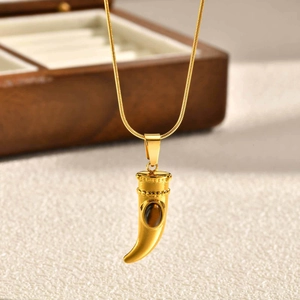 Dettaglio del ciondolo corno cornicello dorato con occhio di tigre su catena snake