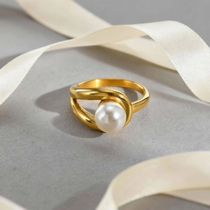 Elegant 18K gold-plated stainless steel ring with a white pearl on silk background