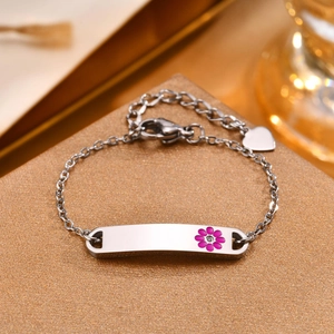 Silver stainless steel bracelet with pink flower ID plate and heart charm on display