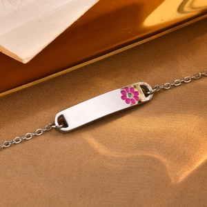 Macro detail of silver steel bracelet featuring a pink enamel flower with a center zircon