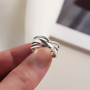 Close-up of irregular S925 sterling silver multilayer intertwined winding ring on a hand