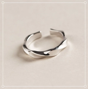 Macro shot of polished S925 sterling silver minimalist twisted texture open ring for women