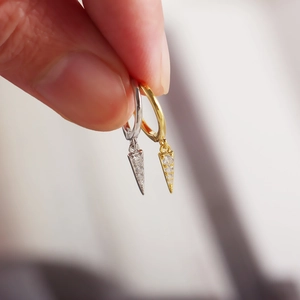 Close-up of minimalist S925 silver hoop earrings with diamond-encrusted triangle charms