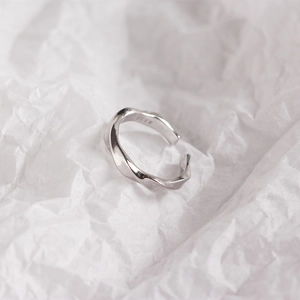 Macro view of S925 sterling silver stamp on minimalist twisted wavy ring band