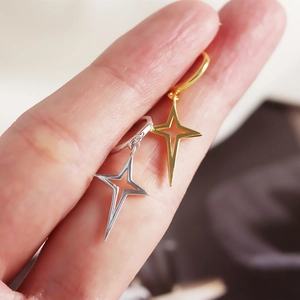 Detailed close-up of S925 sterling silver star hoop earrings in gold and silver finish
