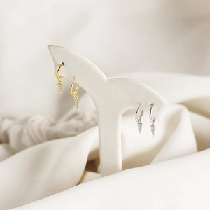 Detailed macro view of minimalist S925 silver triangle earrings with micro-inlaid diamonds