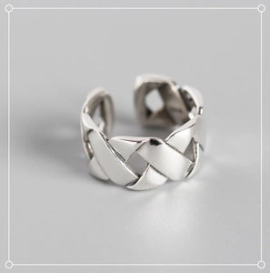 Close-up of S925 sterling silver ring featuring a detailed woven texture and adjustable open band