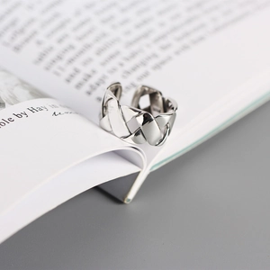 Macro view of woven S925 sterling silver ring showing the 925 purity hallmark detail