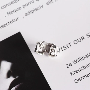 Detailed macro view of S925 sterling silver ring with woven quilted pattern texture