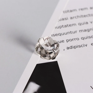 Macro shot of 925 sterling silver ring showing interlaced braided hollow design details