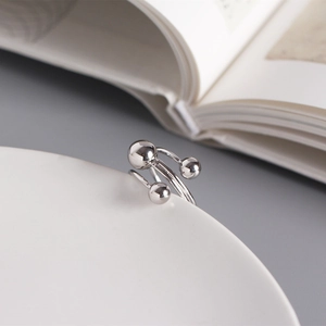 Macro detail of triple-layer silver S925 minimalist spiral ring with polished beads