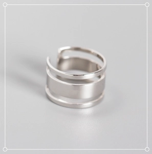 Macro view of triple-layered minimalist S925 sterling silver ring with smooth finish