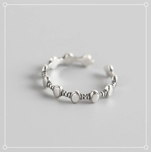 Macro detail of S925 sterling silver open ring with vintage beaded texture and oval links
