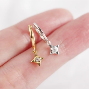 Close-up of gold and silver S925 sterling silver star hoop earrings with zircon