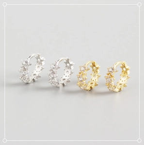 Detailed view of silver and gold S925 sterling silver star-shaped zircon earrings