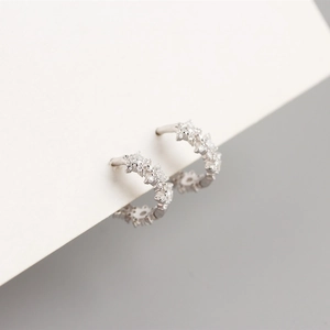 Detailed side view of 925 sterling silver hoop earrings with sparkling star zircon pavé