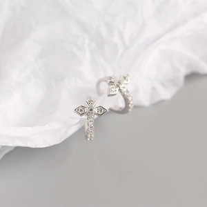Macro detail of S925 sterling silver clover earrings with sparkling cubic zirconia stones