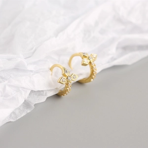 Detailed view of gold S925 silver cross hoop earrings with sparkling cubic zirconia stones