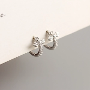 Detailed macro view of S925 sterling silver hoop earrings with diamond clover patterns