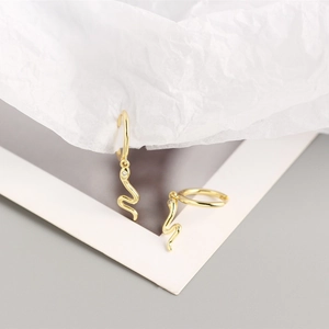 Close-up of gold snake pendant earrings in S925 sterling silver with zircon accents