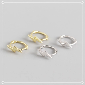 Detailed view of minimalist lightning bolt hoop earrings in gold and silver finish