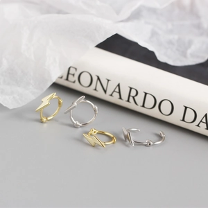 Detail of lightning bolt sterling silver hoop earrings in gold and silver finishes