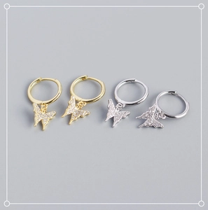 Detail of silver and gold butterfly hoop earrings with sparkling cubic zirconia pavé wings