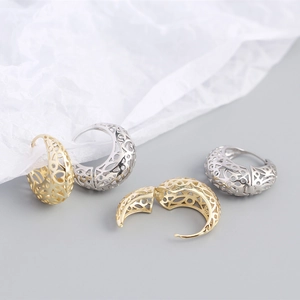 Close-up of hollowed-out S925 sterling silver hoop earrings in gold and silver finish